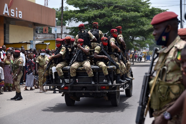 Soldiers from the Republic Guard escort incumbent President Denis Sassou Nguesso as he leaves the polling station in Brazzaville, March 21, 2021. REUTERS/Olivia Acland via GalloImages